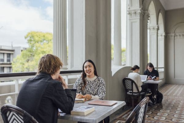 Students sitting and chatting on Medley Hall's balcony