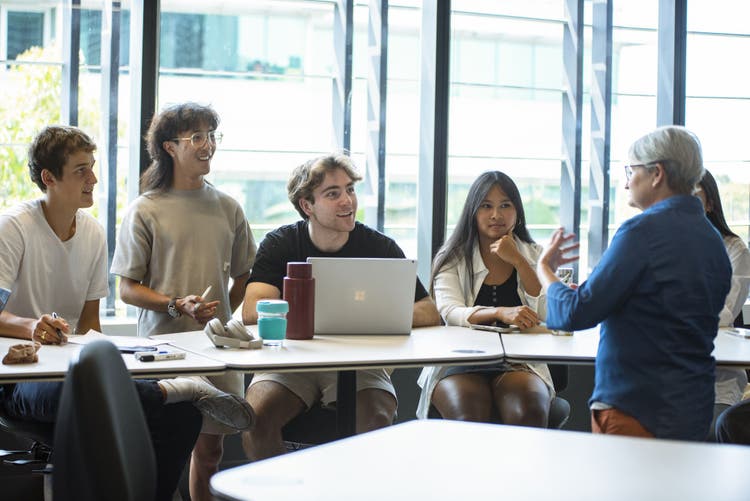 Group of students in Arts West classroom with academic