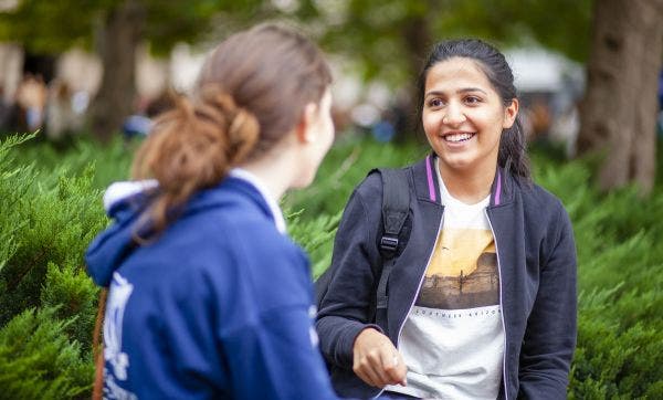 Student ambassador speaking with student on campus