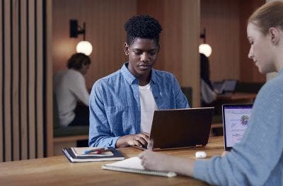 Two students studying on their laptops