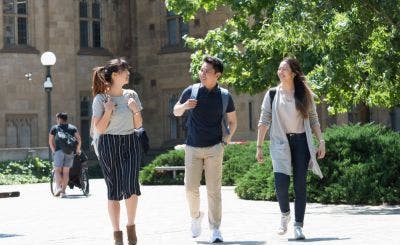 Three students walking together on campus