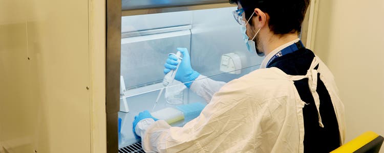 A scientist working in a UOM genomics laboratory.