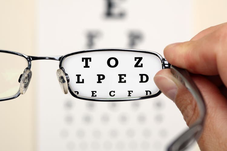 Optometrist holding a pair of glasses