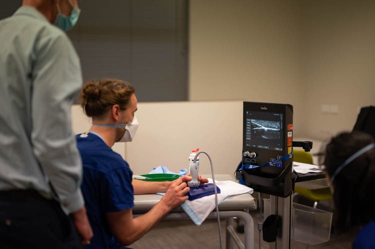 Doctor practicing ugpva on a blue block