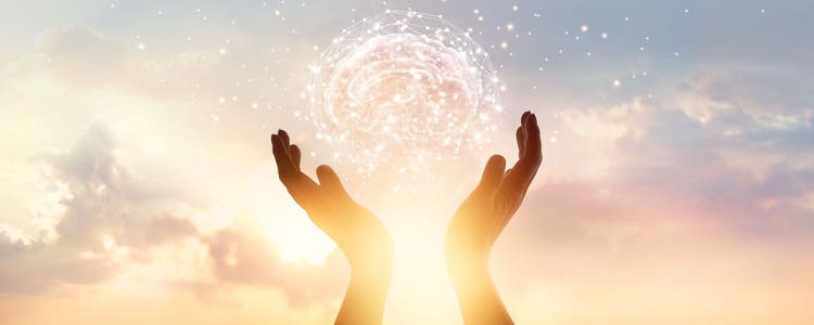 An abstract image of palm hands holding an abstract brain with network connections in the air. A skyline and city building is in the background.