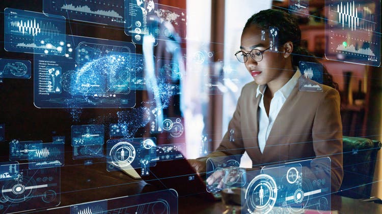 Image of woman at computer looking at data