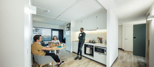 Three students chatting in their apartment