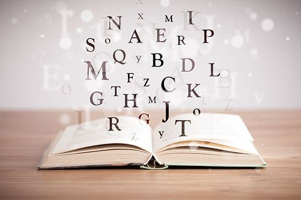 open book with hovering letters above