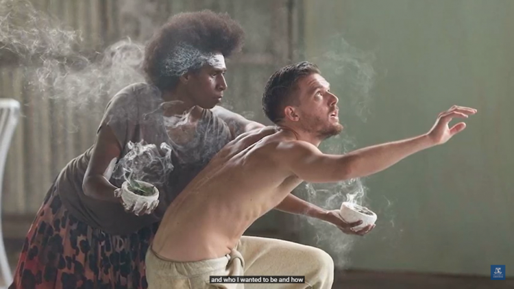 Photo of Daniel Riley performing dance with an aboriginal character on stage