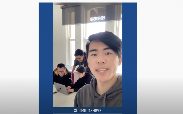 Bachelor of Commerce student Nathan talking and smiling to camera with a group of students working together on a laptop in the background