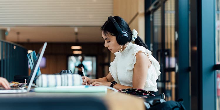 Student studying with headphones