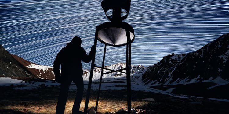 Scientist looking at night sky