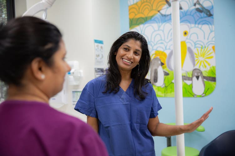 Smiling medical student talking to a colleague
