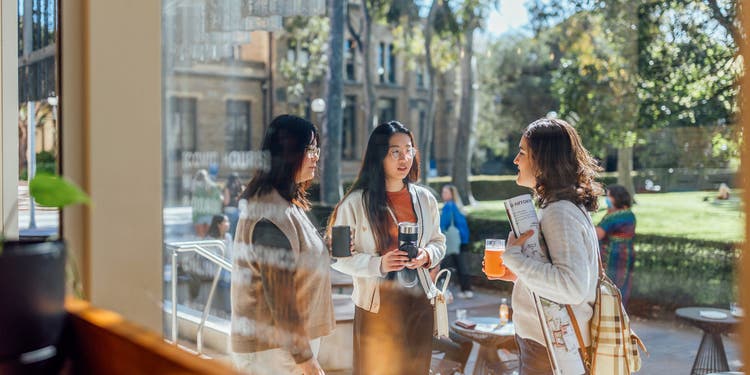 Three students having coffee on campus