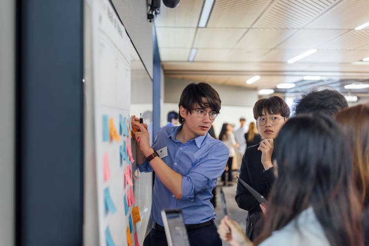 Students infront of a whiteboard