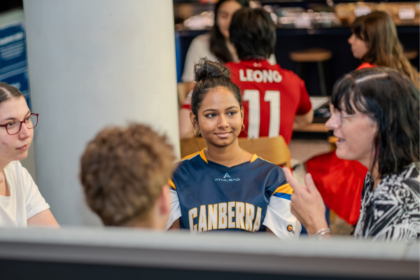 Christine sits with a small group of Hansen Scholars